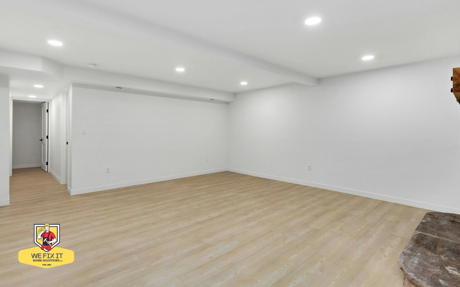 Finished basement with recessed lighting, white walls and wood-look flooring